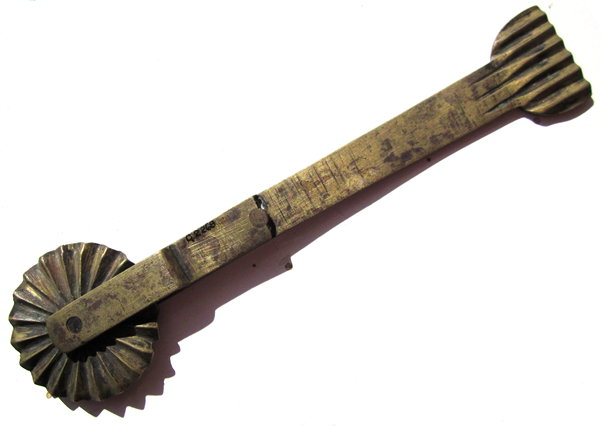 A brass pastry cutter and crimper, dating from around 1900. It can be found at Market Lavington Museum