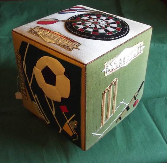1987 made sports themed cube, produced by members of the Darby and Joan Club in Market Lavington