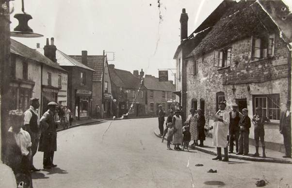 Church Street in about 1932 with Tom Haines, the Market Lavington town crier and Granny Cooper.