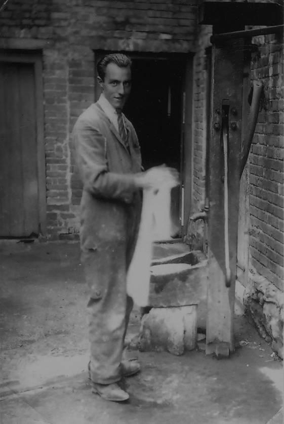 Arthur Cooper uses the Market Place water pump in the 1930s